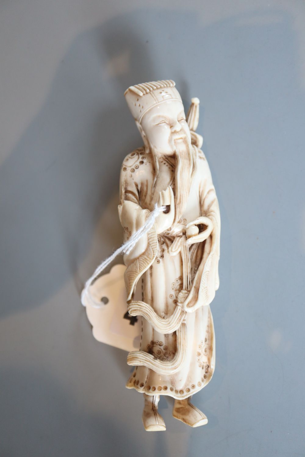 A Chinese ivory figure of Lu Dongbin, early 20th century, H. 14.5cm